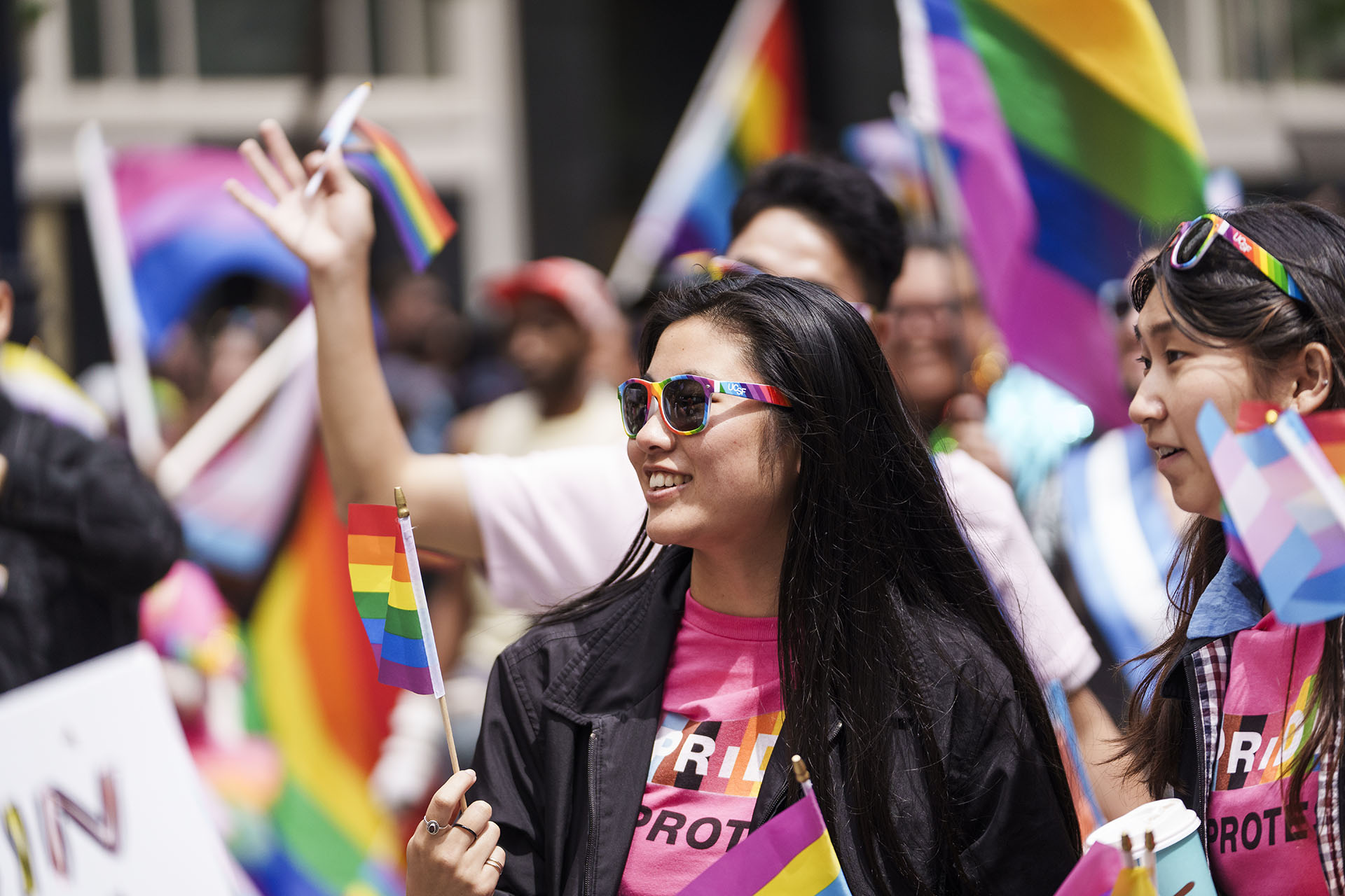 Two UCSF community members participate in the 2023 San Fancisco Pride parade.